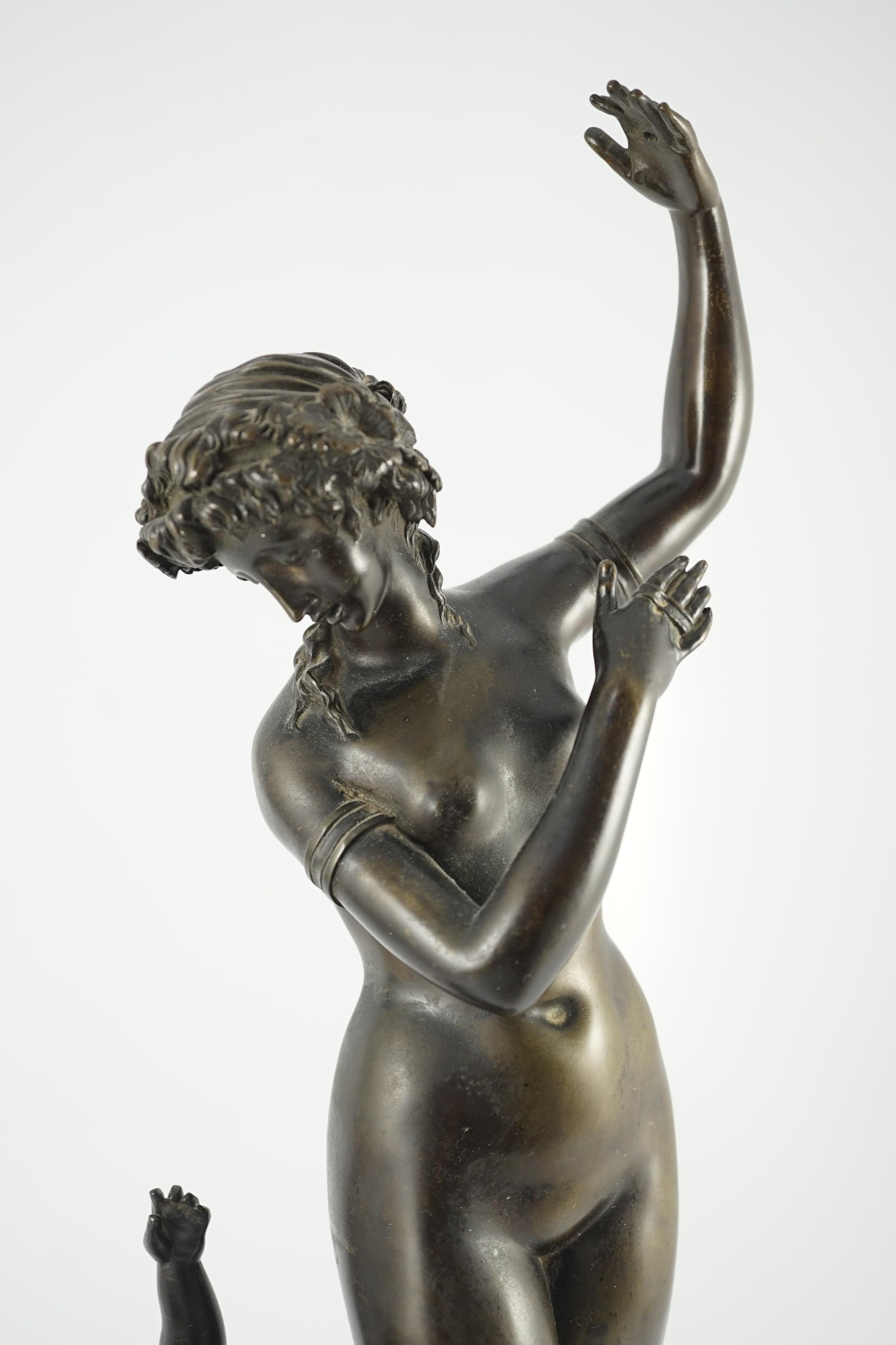 A 19th century French bronze group of a muse dancing alongside a faun, 24cm wide, 52cm high